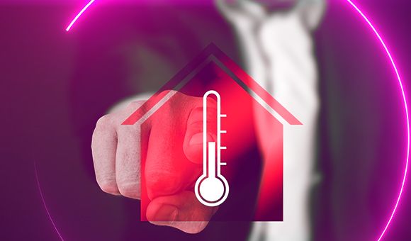 rotes Haussymbol mit eingelassener Thermometer Grafik als Symbol für die kalte Jahreszeit